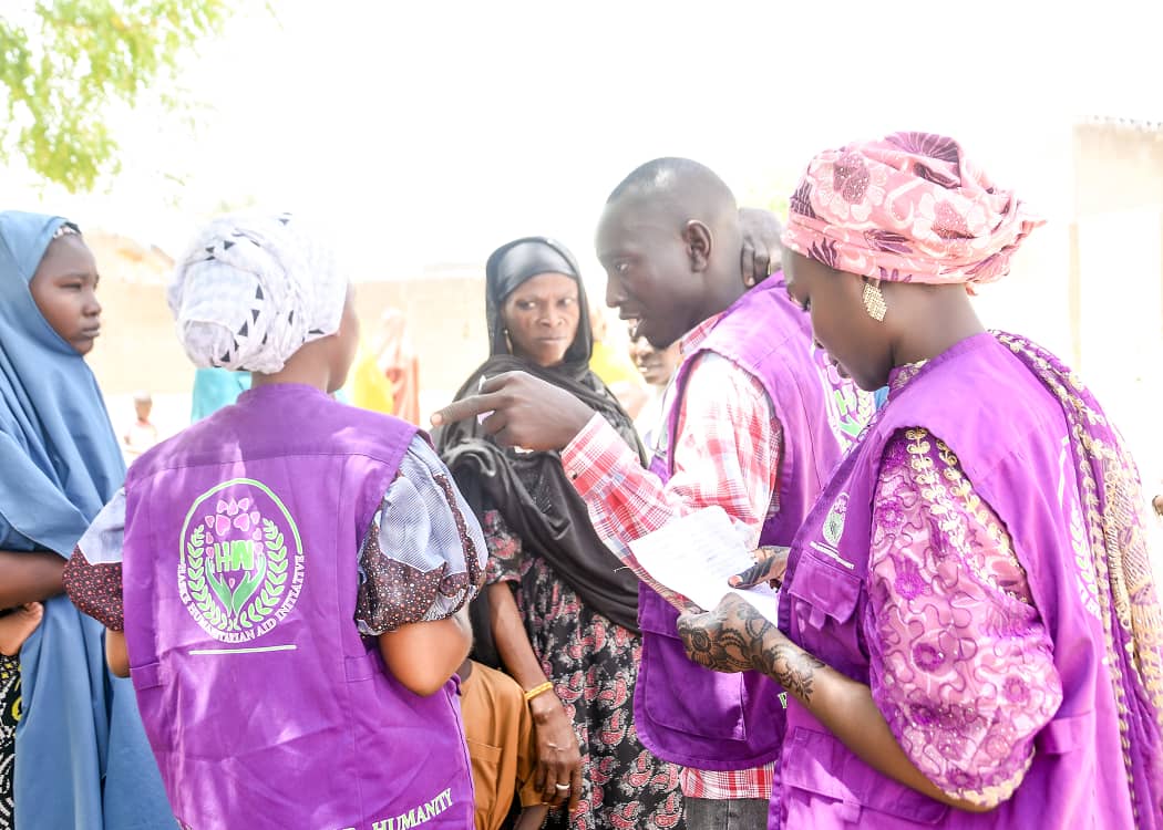 HHAI field staff consulting with community members